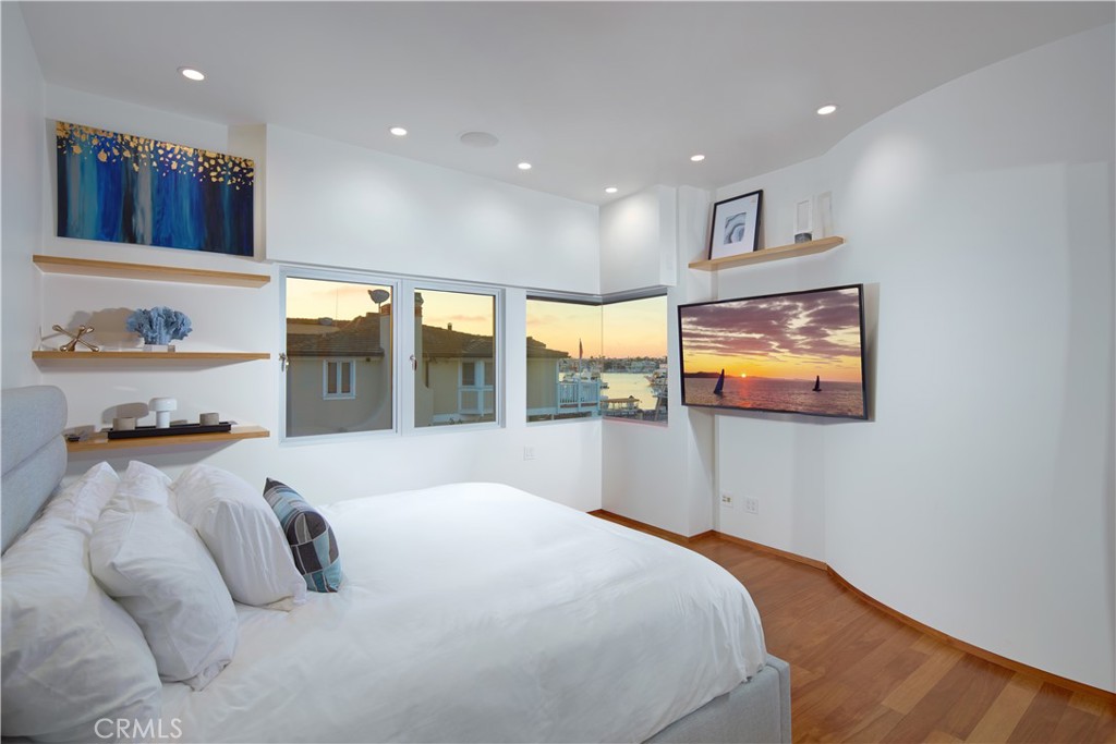 1042 West Bay Avenue Newport Beach, CA 92661 - Photo 29 of 37 a bedroom with a bed and a television