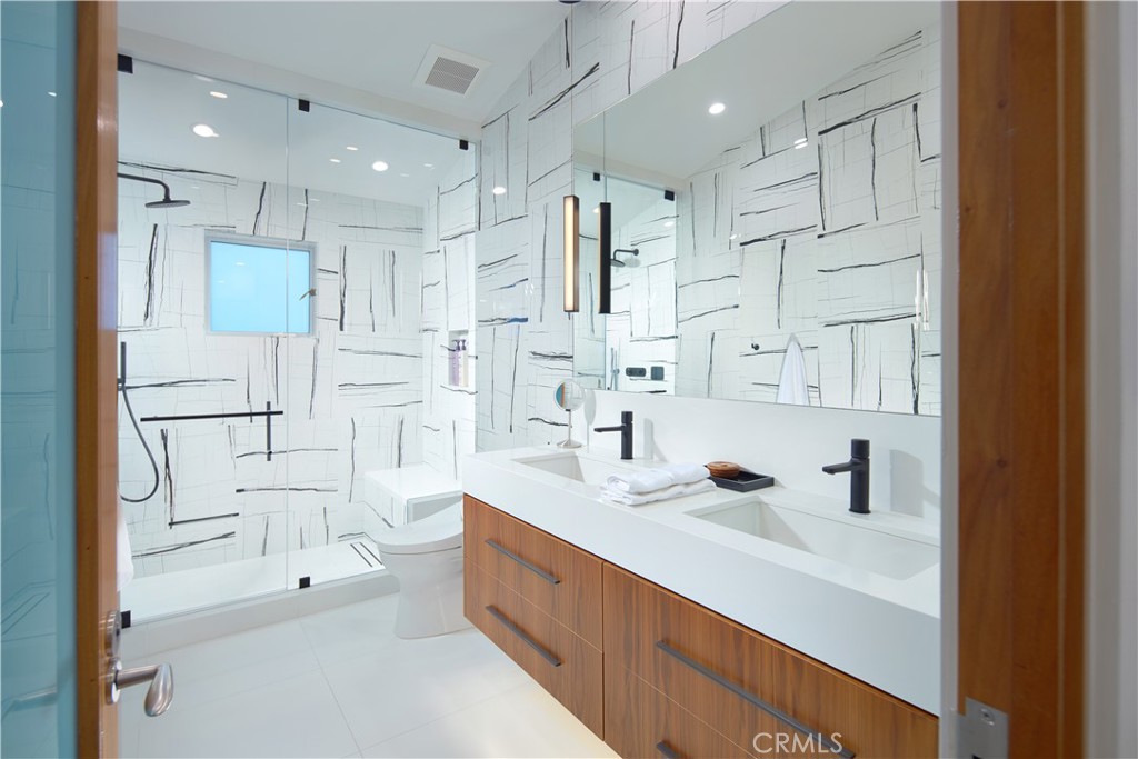 1042 West Bay Avenue Newport Beach, CA 92661 - Photo 30 of 37 a spacious bathroom with double vanity sink a mirror a shower and bathtub