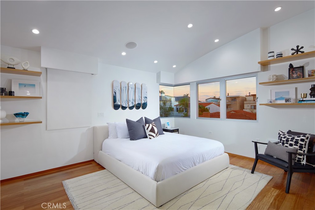 1042 West Bay Avenue Newport Beach, CA 92661 - Photo 32 of 37 a bedroom with a large bed and a wooden floor