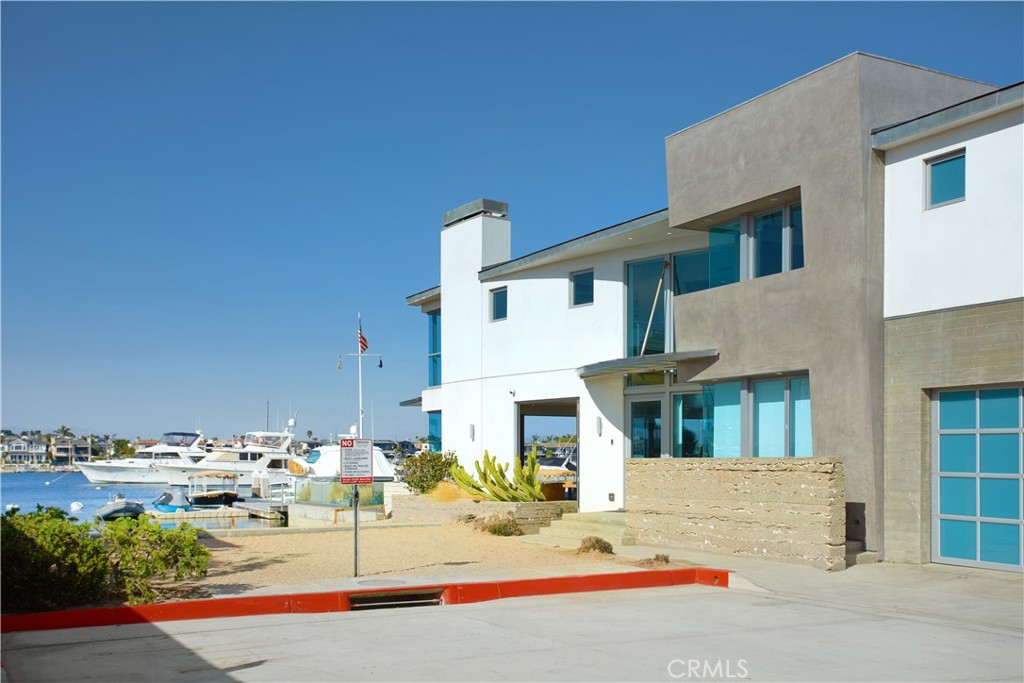 1042 West Bay Avenue Newport Beach, CA 92661 - Photo 35 of 37 a view of a white house with swimming pool in front of it