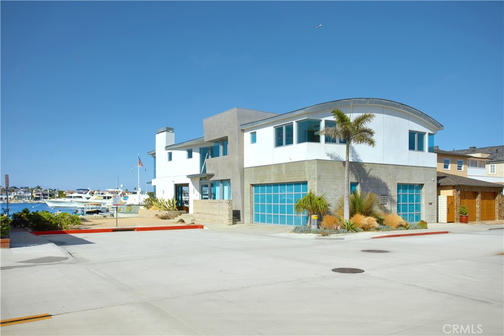 1042 West Bay Avenue Newport Beach, CA 92661 - Photo 36 of 37 a front view of a house with a sitting area