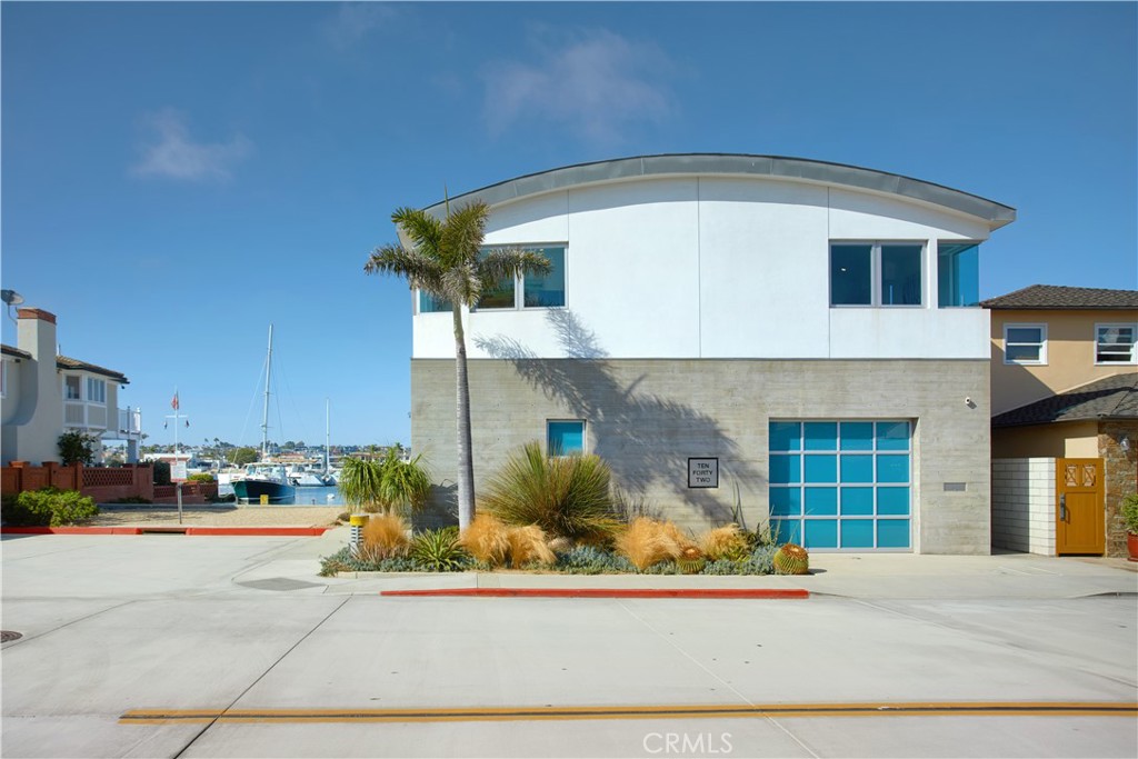 1042 West Bay Avenue Newport Beach, CA 92661 - Photo 37 of 37 a front view of a house with a yard and garage