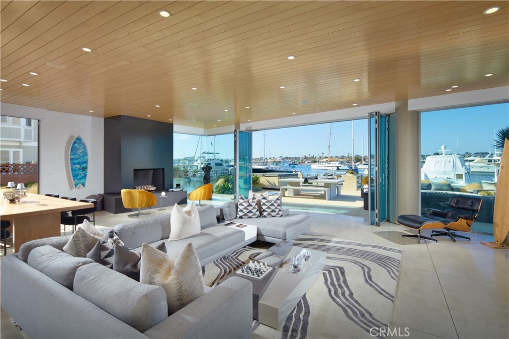 1042 West Bay Avenue Newport Beach, CA 92661 - Photo 6 of 37 a living room with furniture and a large window