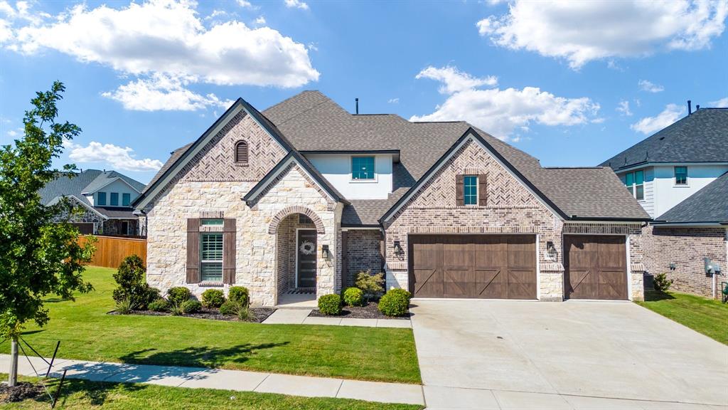 9300 Simmons Road Argyle, TX 76226 - Photo 1 of 1 a front view of a house with a yard and garage