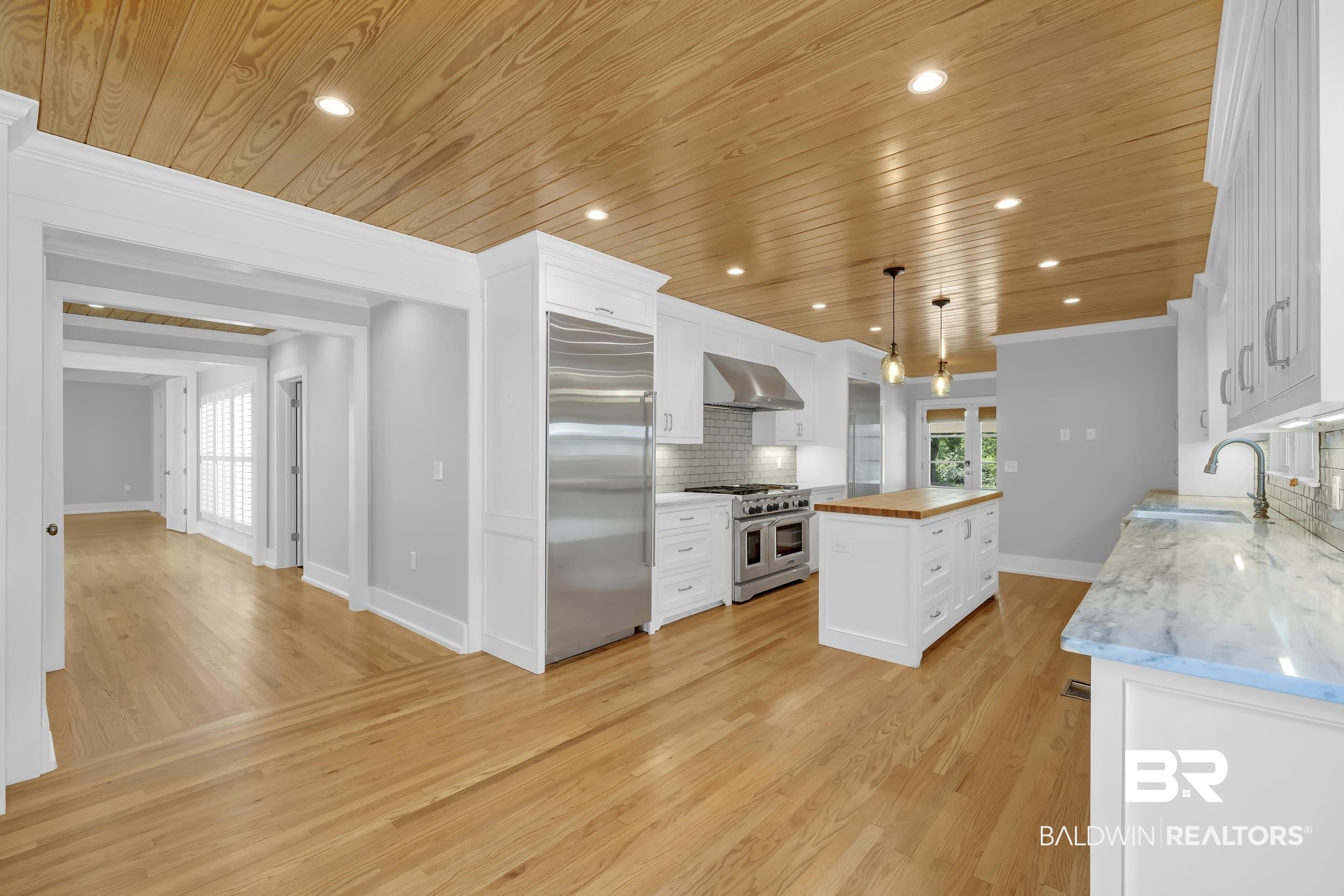 43199 Pine Grove Road Bay Minette, AL 36507 - Photo 42 of 71 Gourmet kitchen featuring a wood-panel ceiling, extensive wood-finish flooring, stainless steel appliances, a center island with a wood countertop, and ample cabinetry with natural stone countertops