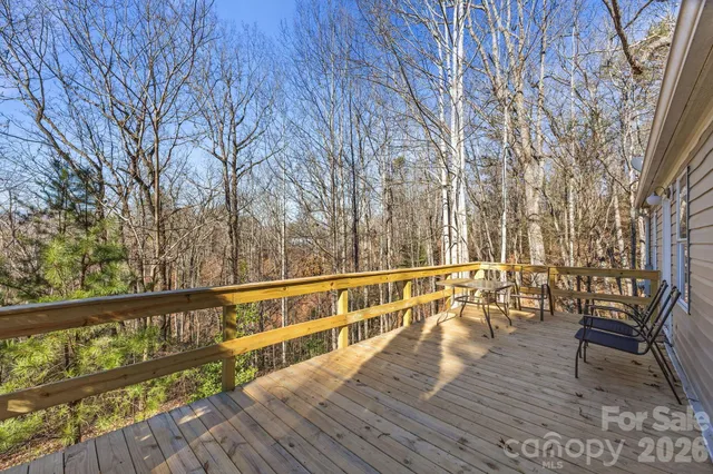 a view of balcony with wooden floor and bench