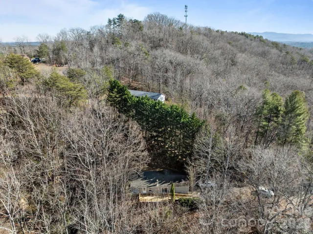 an aerial view of a house with mountain view