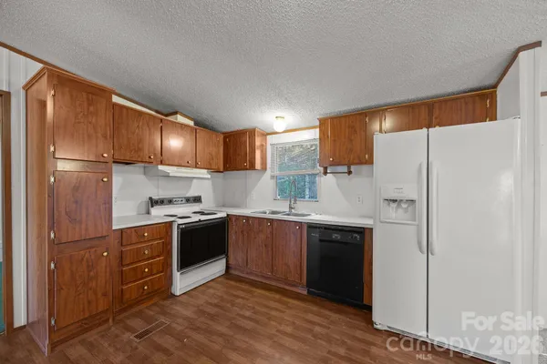 a kitchen with stainless steel appliances white cabinets and a refrigerator