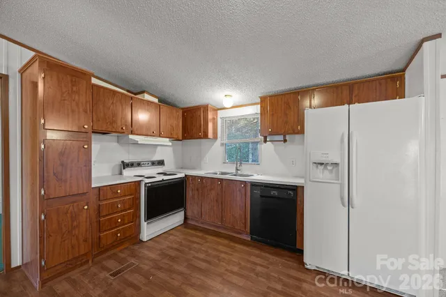 a kitchen with stainless steel appliances white cabinets and a refrigerator