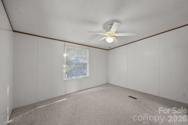 an empty room with fan and fan
