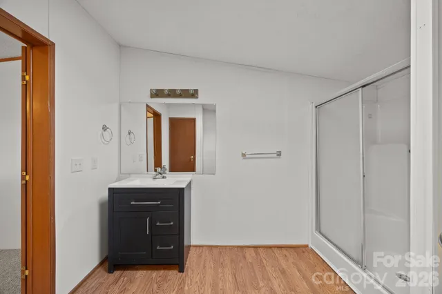 a bedroom with a bed and a mirror