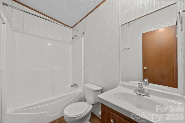 a view of hallway with wooden floor