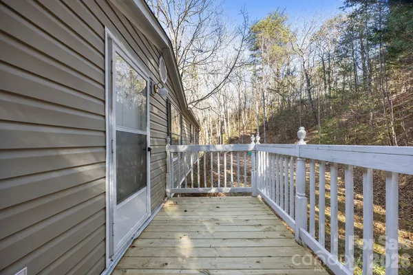 a view of a balcony with wooden floor and fence