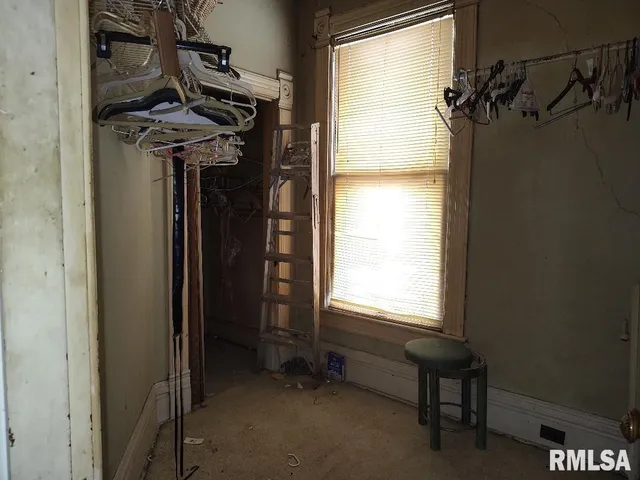 a dining room with furniture a chandelier and window