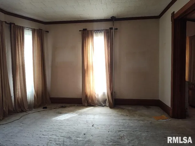 a kitchen with granite countertop a dining table chairs refrigerator and sink