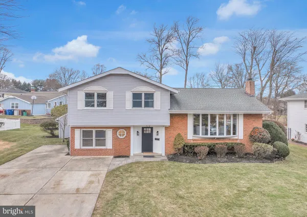 a view of a brick house with a yard