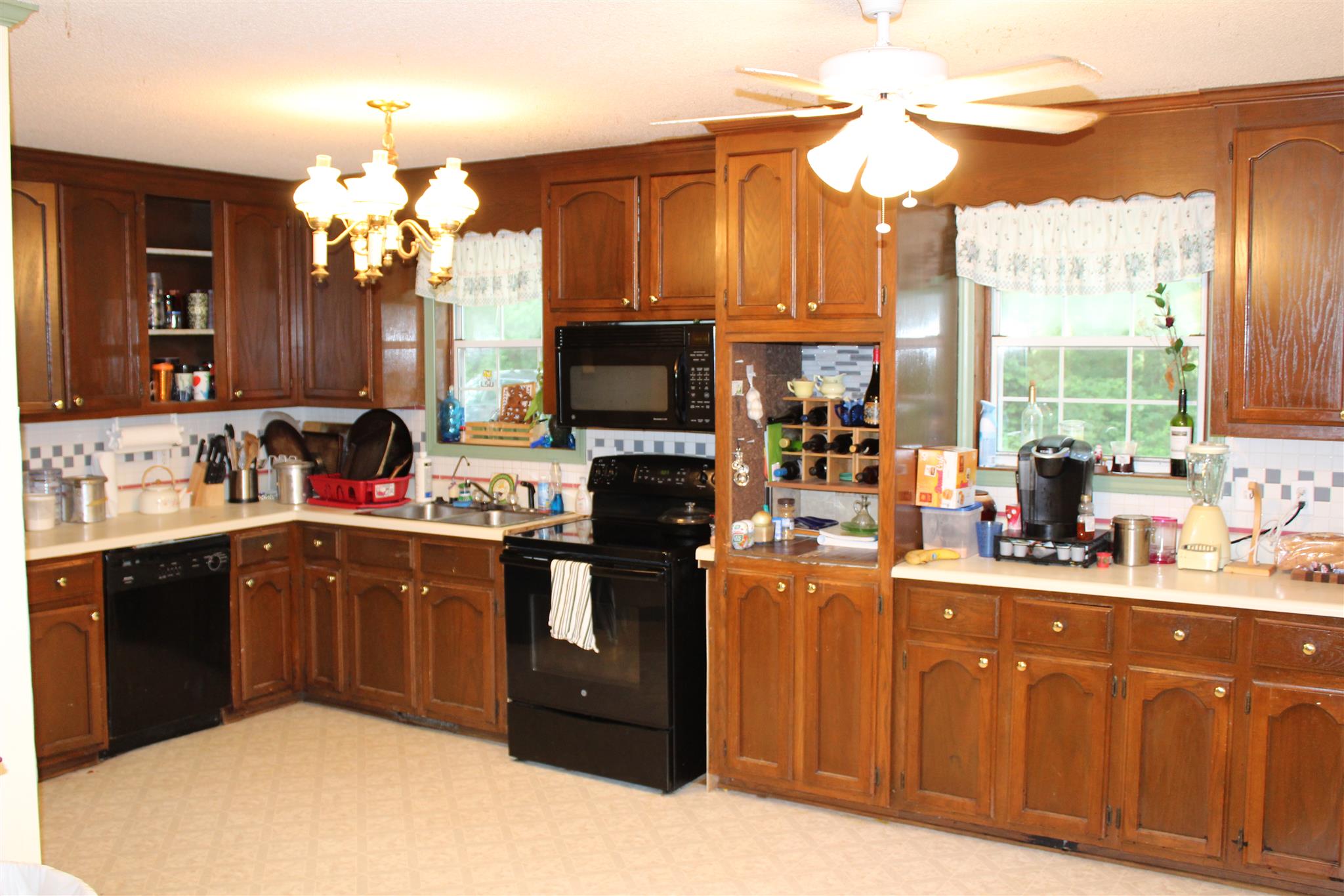 4749 Ollie Chunn Road Spring Hill, TN 37174 - Photo 10 of 11 a kitchen with kitchen island granite countertop a sink appliances cabinets and a counter top space