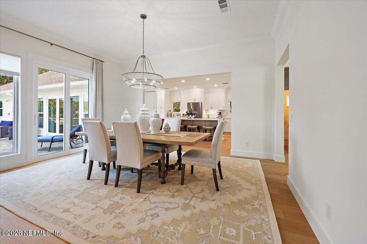 2253 Beachcomber Trail Atlantic Beach, FL 32233 - Photo 8 of 42 a dining room with furniture a chandelier and a rug