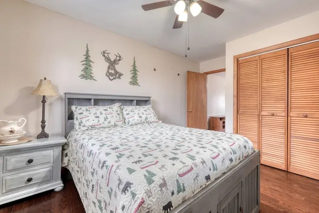 a bedroom with a bed and a chandelier