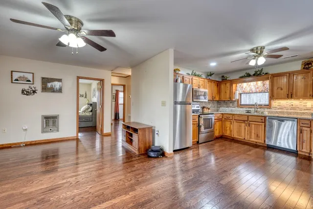 a open kitchen with cabinets a refrigerator and a stove