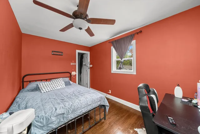 a bedroom with a bed and a desk