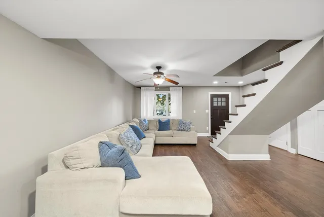 a living room with furniture and wooden floor