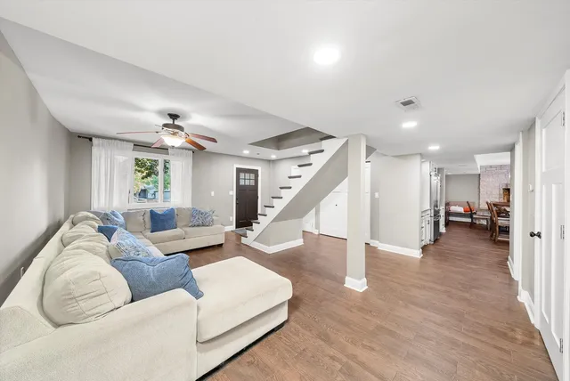 a living room with furniture and wooden floor