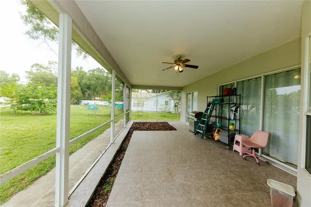 a view of a chairs and table in patio with a yard