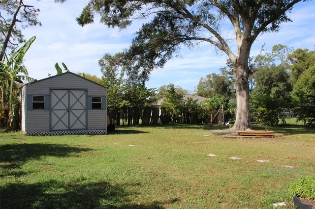a view of a swimming pool and trees in the background