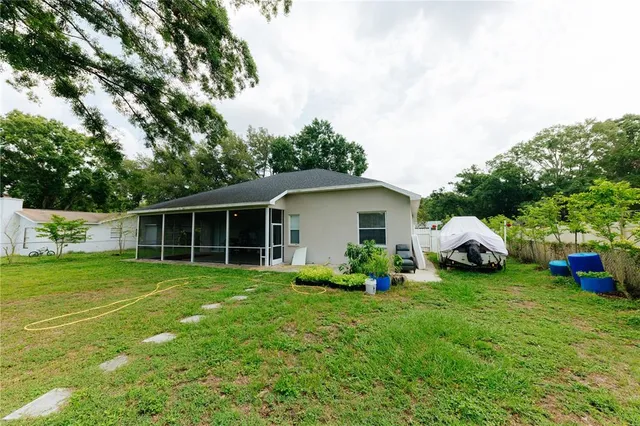 a view of a house with a yard and sitting area