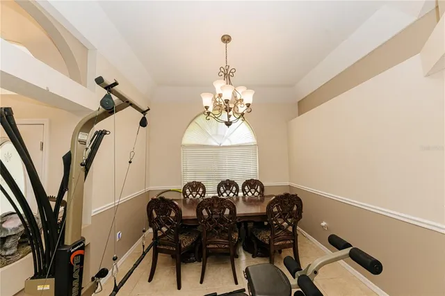 a view of a dining room with furniture and a chandelier