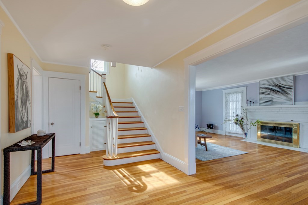 11 Angier Circle Newton, MA 02466 - Photo 3 of 21 a view of a livingroom with wooden floor and a fireplace