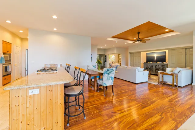 a living room with dining room and wooden floor