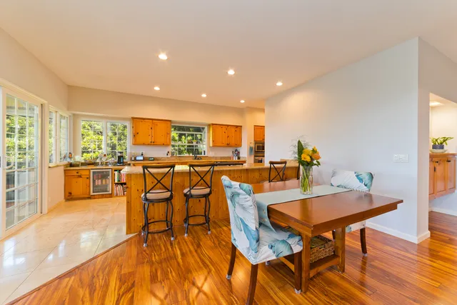 a living room with dining room and wooden floor