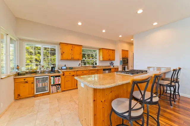 a large kitchen with a table and chairs