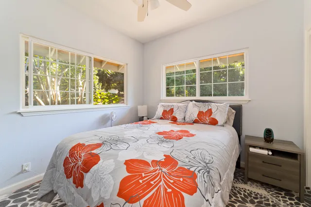 a bedroom with a bed and a window