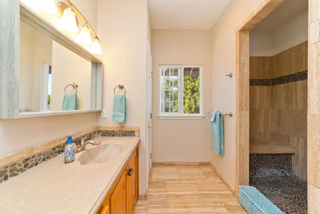 a bathroom with a sink double vanity and a mirror