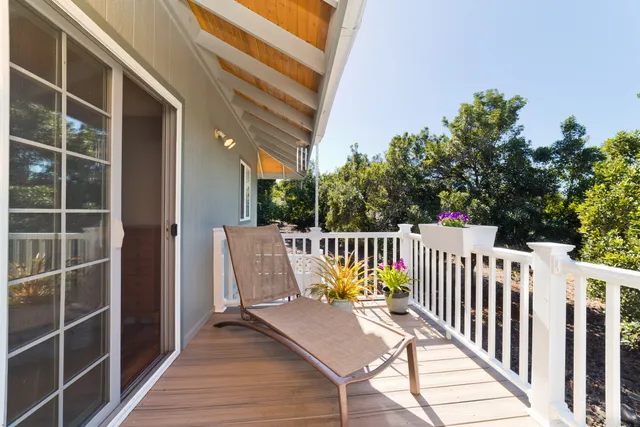 a view of balcony with wooden floor and seating space