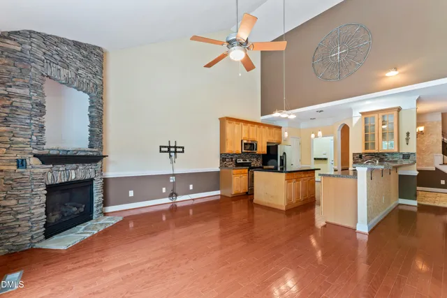 a living room with fireplace furniture and a wooden floor