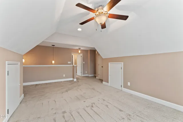 an empty room with ceiling fan and window