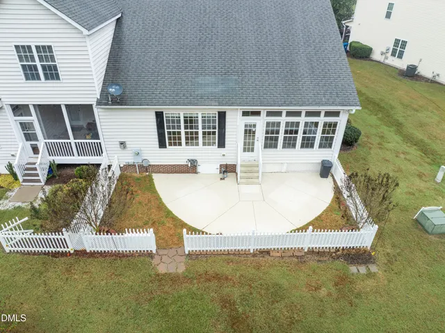 an aerial view of a house with swimming pool and sitting space
