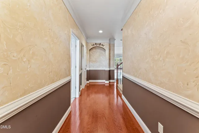 a view of a room with wooden floor and furniture
