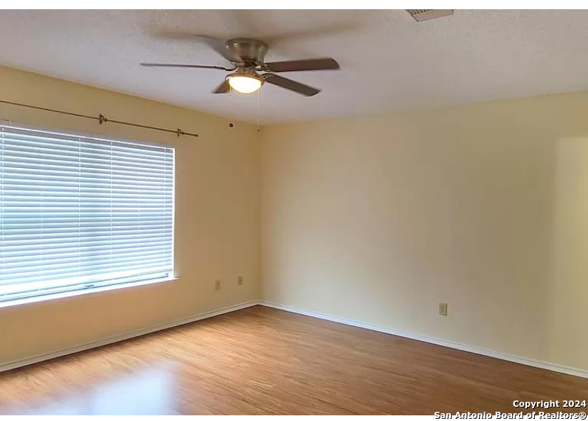 8311 Tavern Point San Antonio, TX 78254 - Photo 11 of 21 an empty room with wooden floor and windows