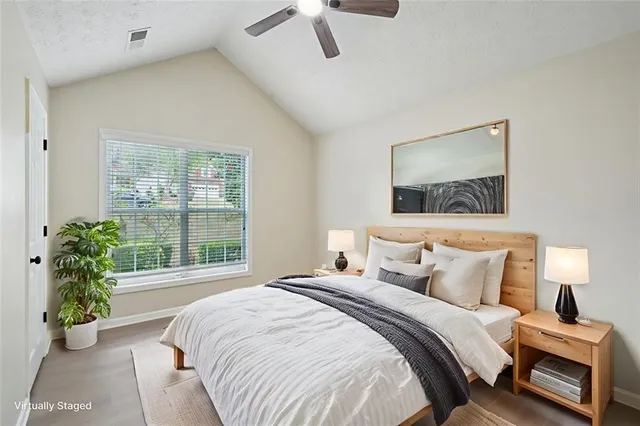 a bedroom with a bed and a window