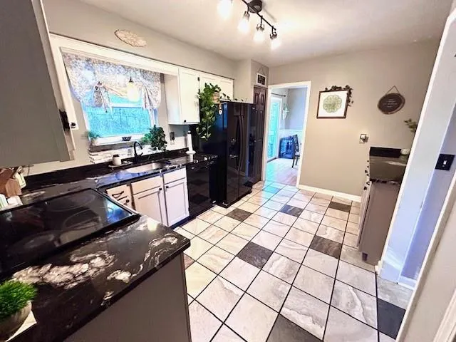 a kitchen with a sink appliances and cabinets