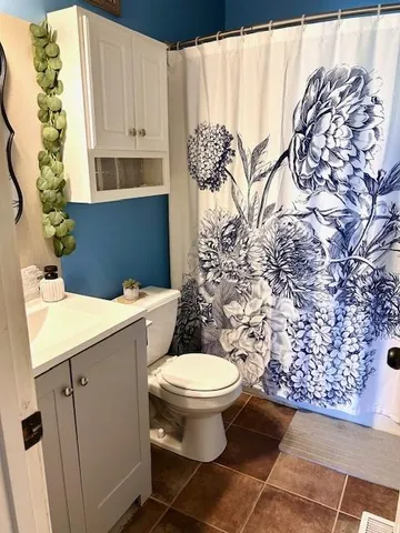 a bathroom with a toilet and a sink