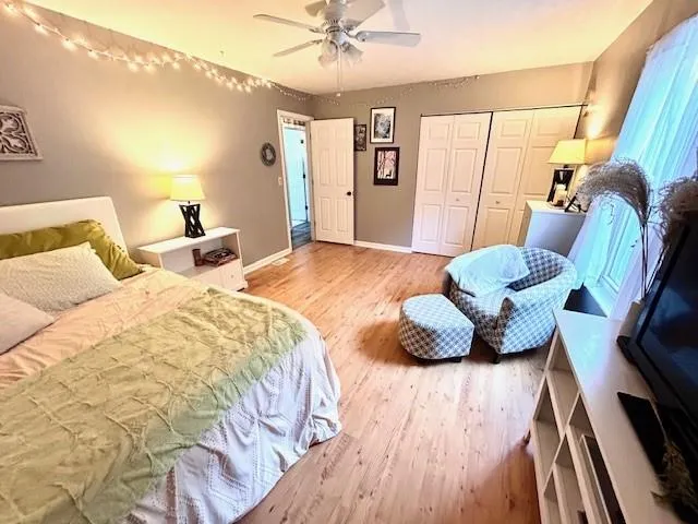 a bedroom with a bed and wooden floor