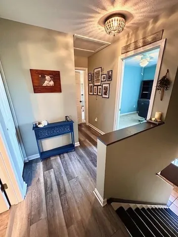 a view of a hallway with wooden floor