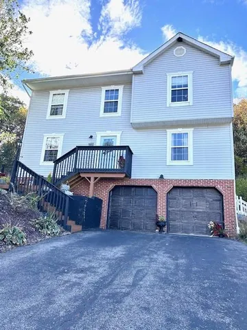 a view of a house with a yard and a garden