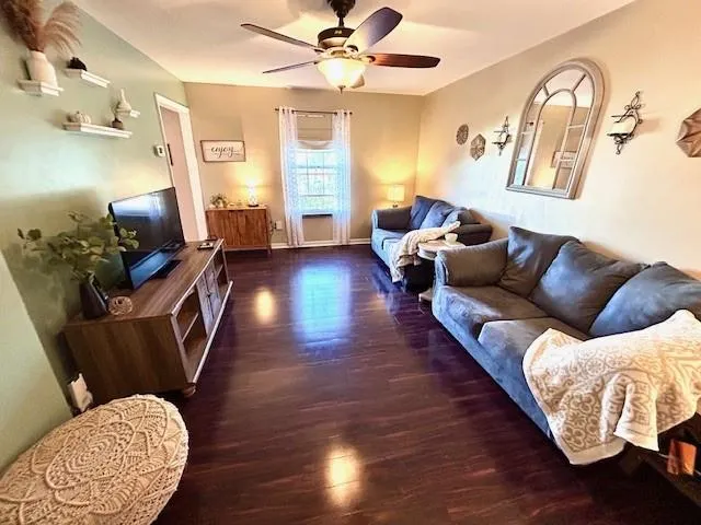 a living room with furniture and wooden floor